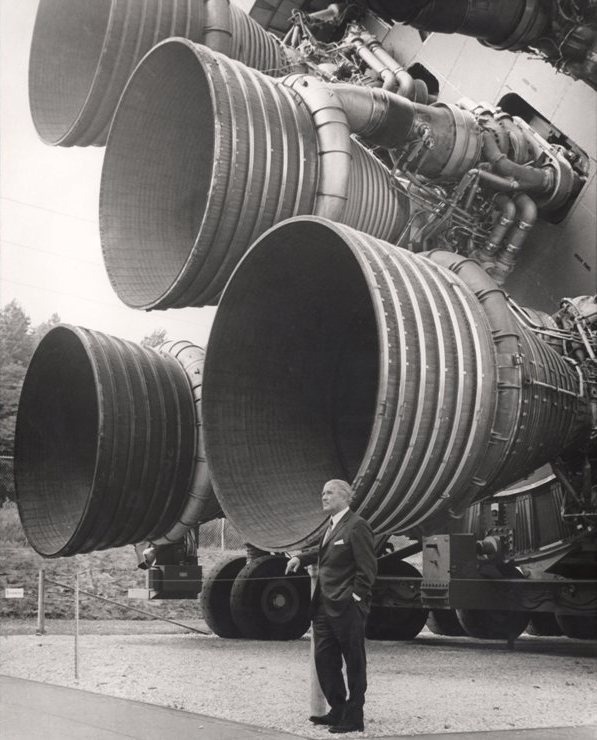 Wernher von Braun vor dem Triebwerk einer Saturn V Rakete